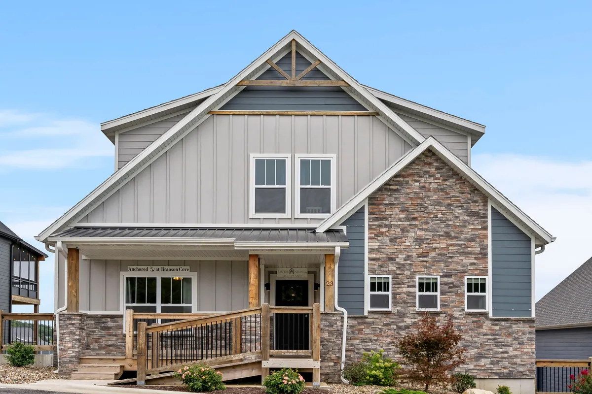 This image displays the inviting front entrance of the property with a stone facade and a welcoming porch, offering a clear, accessible pathway to the door. The exterior is thoughtfully designed, hinting at ease of entry for guests with mobility considerations and establishing a sense of hospitality from the first point of arrival.